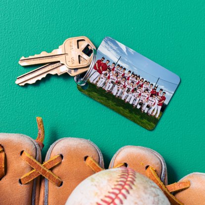 metal keychain with a baseball team photo next to a ball and a glove