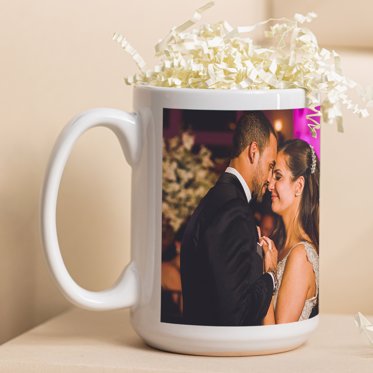 A personalized photo mug from Mpix filled with confetti and featuring a photo of a couple celebrating their first dance at their wedding. 
