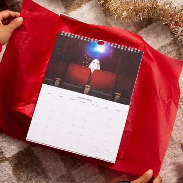 A personalized monthly wall calendars from Mpix featuring a large photos celebrating the month above a typical calendar grid.