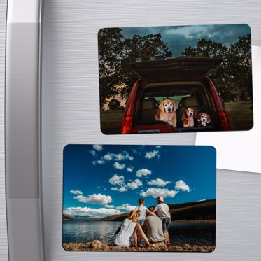 Photo Magnets from Mpix on the fridge with family photos of a trip to the mountains, one standing by a lake and the other in the tent with their dog. 