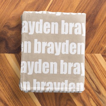 A personalized name blanket from Mpix with "brayden" written in white font on a light brown background. 