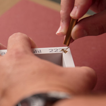 a framed print being crafted by hand and inspected for quality in our lab