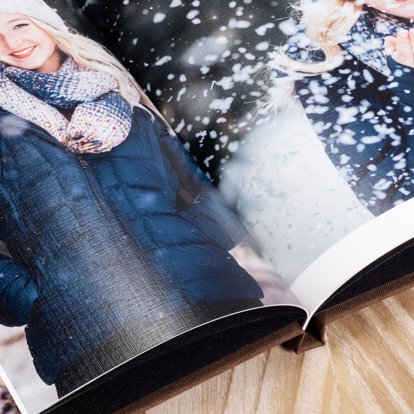An open spread of a classic photo book showing off the magazine style page option and custom layout designs.