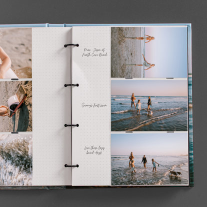 An open Slip-In Photo Album from Mpix showing the three-ring binder, interior pages, and photo prints slipped into the pages.