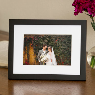 An Mpix Tabletop Framed Photo Print in a Black Frame & White Window Mat with a wedding photo of the bride and groom