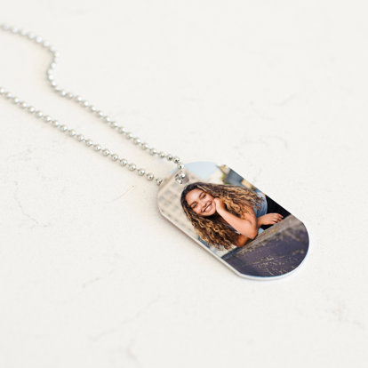 Graduation photo printed on a dog tag necklace.