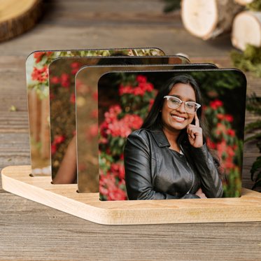 Four Personalized Photo Coasters from Mpix in a wooden stand featuring senior photos of an upcoming graduate. 