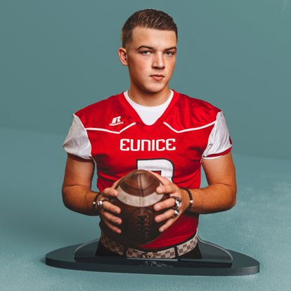 a photo statuette of a football player posing for his senior photos