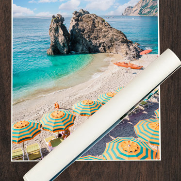 A business poster featuring a photo of a beach at a resort with colorful umbrellas an beach chairs.