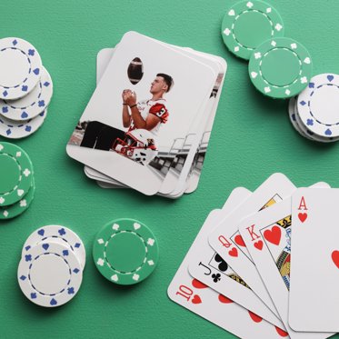personalized playing cards laid out on a table next to poker chips