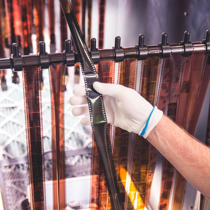 A worker in our lab is hanging strips of film