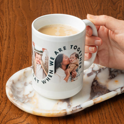 Hand holding a white ceramic photo mug featuring photos of a mom and her toddler son with the words 'Every day is a great day when we are together' in bold black text.