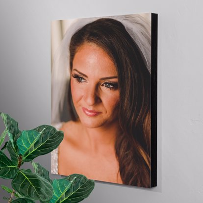 a large foam mounted standout on the wall featuring a portrait of a brown haired woman