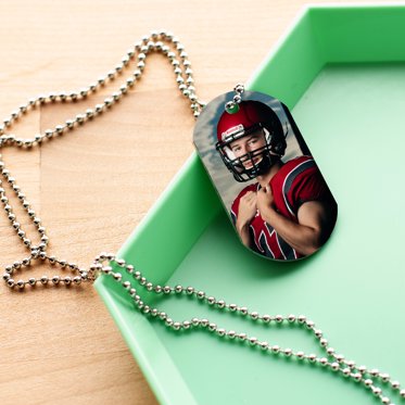 Metal Dog Tags from Mpix on a chain featuring a personalized sports photo. 