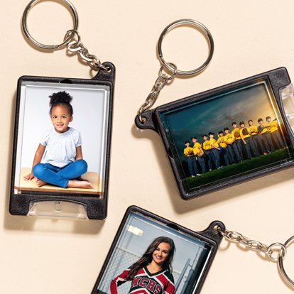 A collection of flashlight keychains featuring family and sports photos.