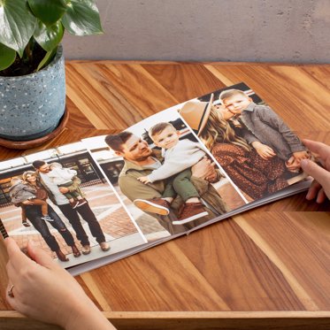 An open softcover book laid on a table showing the seamless layflat spreads.