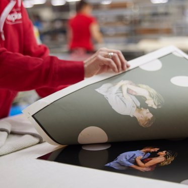 a worker at the Mpix lab creates a metal print using a dye sublimation process