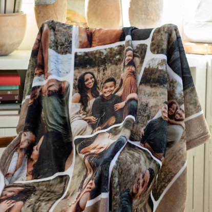 A personalized photo blanket featuring a collage of photos draped over a chair.