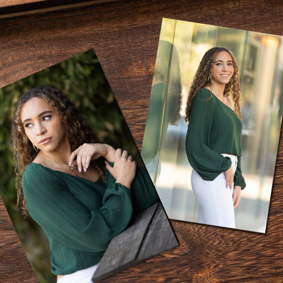 Two 5x7 photo prints featuring a high school senior posing outside. She’s wearing a dark green top and white jeans.