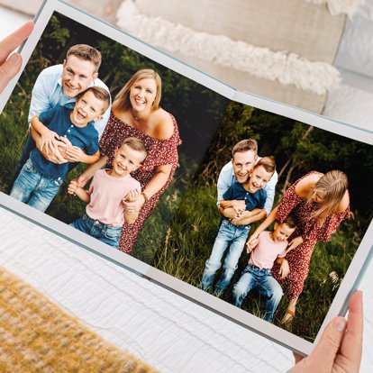 An everyday family photo book with seamless full page spreads featuring a family portrait session.