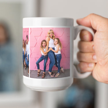 A white mug featuring a photo of a family outside with a holiday message of 'Merry 24"