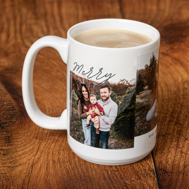 A white mug featuring a photo of a family outside with a holiday message of 'Merry".