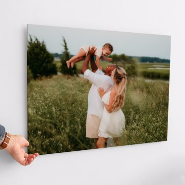 Acrylic photo print from Mpix being hung on a wall using it's french cleat hanging system featuring a family walking and posing in a meadow for their family portrait session. 