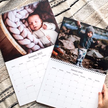 Two wall calendars from Mpix, one with binding on top and one with the binding in the middle, featuring large personalized photos for the months.