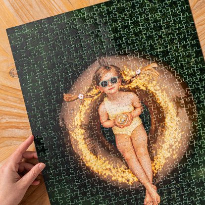 A hand positioning a completed photo puzzle featuring a summery image of a young girl.