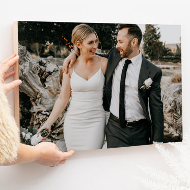 A wood print of a couple celebrating on their wedding day being properly cared for. 