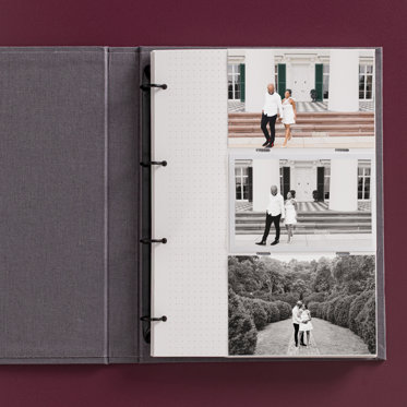 An open photo album with pockets showing the 4-ring binder and 4x6 prints slipped into the sleeves.