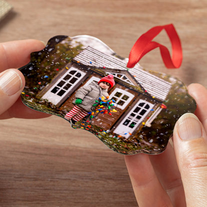 An oval shaped photo ornament with a photo of a woman holding her puppy with the text 'Walter's 1st Christmas.'