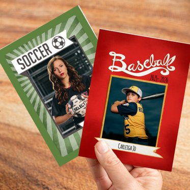 A hand holding two trader cards from Mpix featuring sports photos and personalized text.