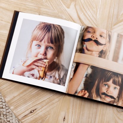 An open spread of a classic photo book showing off the magazine style page option and custom layout designs.