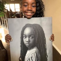 A smiling girl holding a large black-and-white portrait print of herself