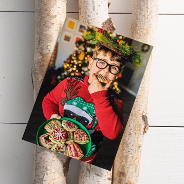 Personalized photo print from Mpix of a young man in a festive Christmas outfit and groucho marx sunglasses holding a plate of Christmas cookies. 