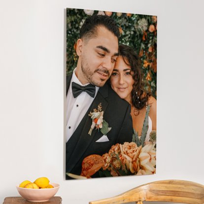 A large acrylic print hung on a home wall and featuring a wedding image of a bride and groom.