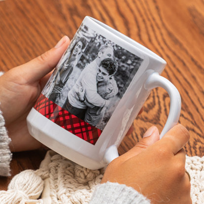 A personalized photo mug with a plaid holiday-themed pattern and large photo.