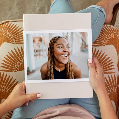 A premium photo book with a skinny dust jacket featuring a graduation photo.