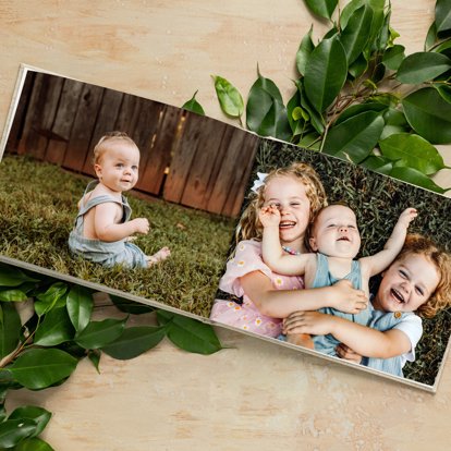 An open photo book from Mpix featuring images on the interior pages of young siblings playing.