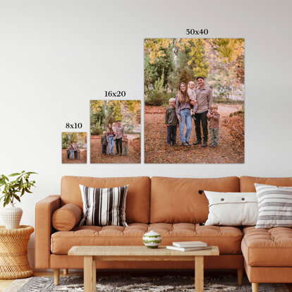 An 8x10", 16x20", and 30x40" print hanging on the wall above a couch. They are next to one another to illustrate the difference in wall space they take up in relation to the couch below.