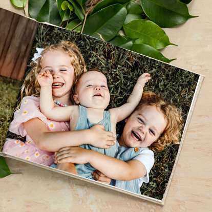 An open photo book from Mpix with pictures on the interior pages of several young children.