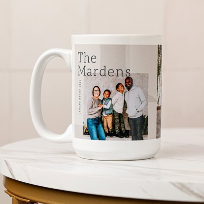 A white personalized photo mug featuring a couple and their two young boys and text that reads their family name, 'The Mardens'.