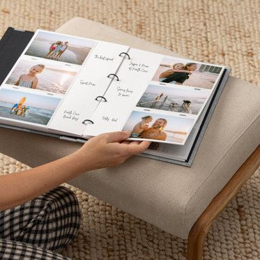 Hands flipping through a Slip-In Photo Album from Mpix. The Album is open to show the three-ring binder, interior pages with hand-written notes, and three 4x6 photo prints on each page.