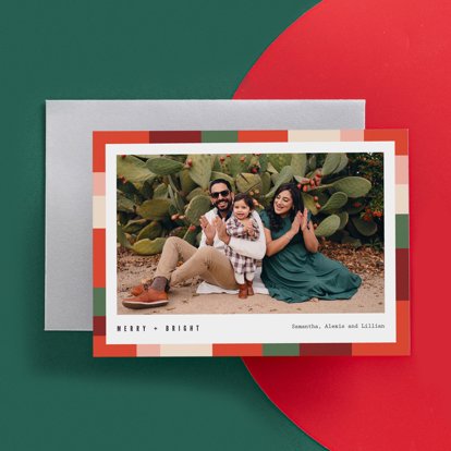 A holiday greeting card with a colorful holiday background, an image of a family, and personalized text.