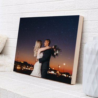A wood photo print from Mpix leading on a counter with an evening skyline shot of a couple embracing on their wedding day. 