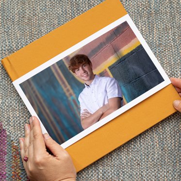 Hardcover Photo Book from Mpix with Yellow Linen Cover and Skinny Photo Dust Jacket featuring a senior photo. 