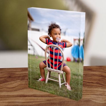 An Acrylic Block displayed on a table and featuring an image of a young child.