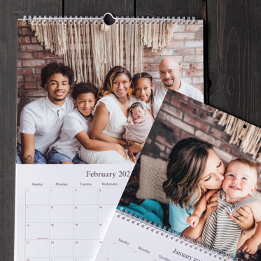 Two Wall Calendars with family pictures and monthly calendar grids.