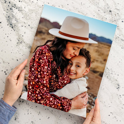 An 8x10 photo print featuring a mother and her son embracing in the desert. 